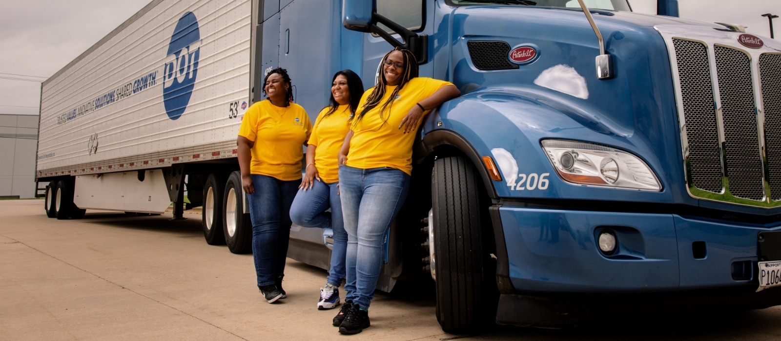 women drivers standing next to DTI truck