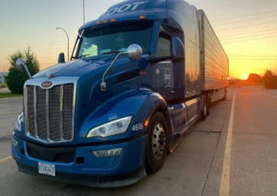 DTI truck on road with sunset
