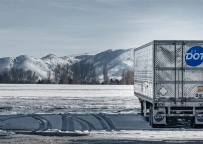 Dot trailer in snow with mountains in background
